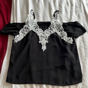 Black tank top with white flowery straps.